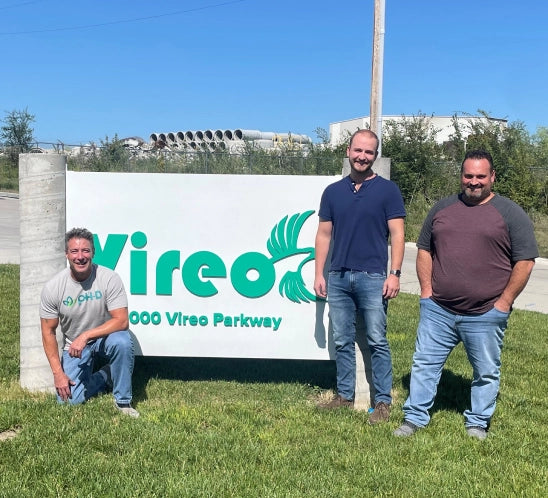Three Vireo Resources employees standing outside near the Vireo sign.